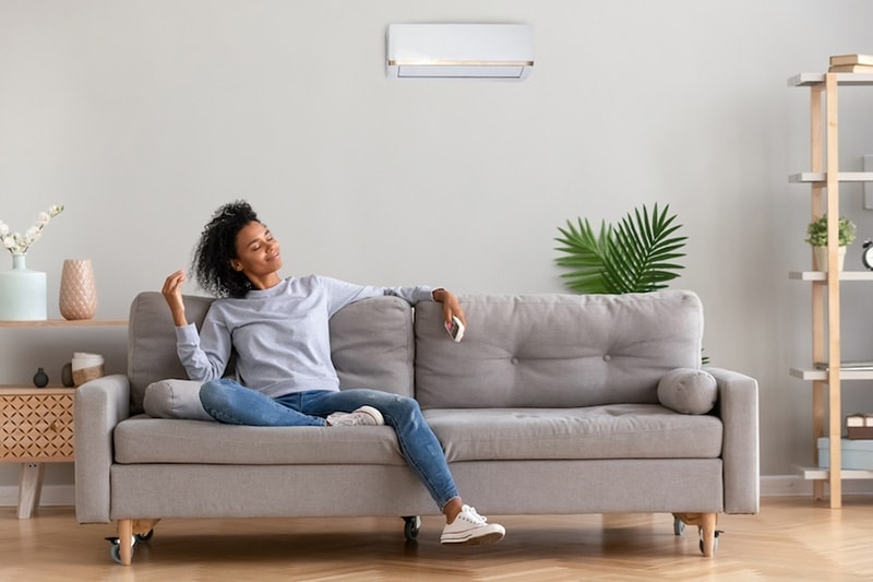 Young woman relaxing on a gray couch